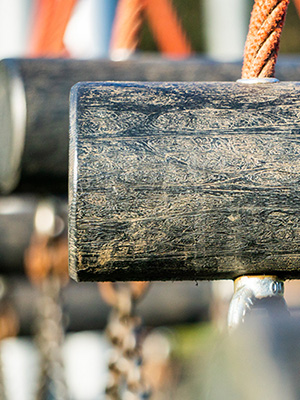 A close up of stepping logs for an outdoor obstacle course at a playground.